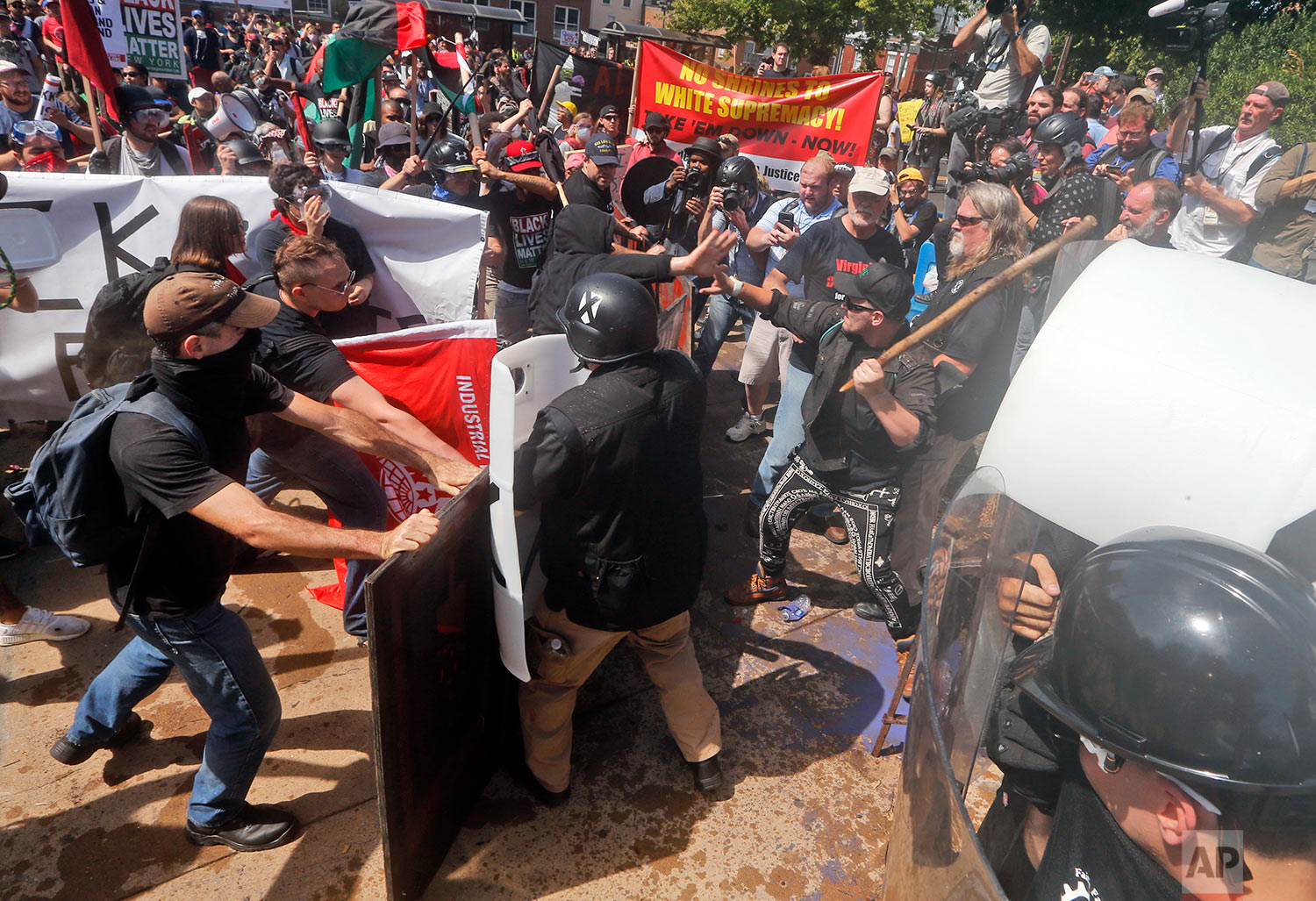  White nationalist demonstrators clash with counter demonstrators at the entrance to Lee Park in Charlottesville, Va., Saturday, Aug. 12, 2017. Gov. Terry McAuliffe declared a state of emergency and police dressed in riot gear ordered people to dispe