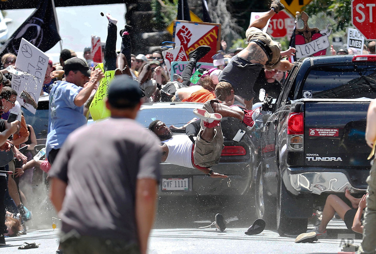  People fly into the air as a vehicle drives into a group of protesters demonstrating against a white nationalist rally in Charlottesville, Va., Saturday, Aug. 12, 2017.  (Ryan M. Kelly/The Daily Progress via AP) 