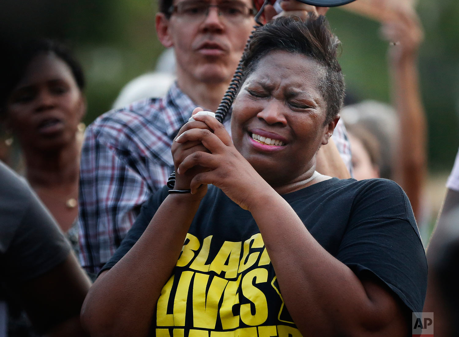  Cara McClure, of Birmingham, Ala, cries during a solidarity gathering Sunday, Aug. 13, 2017, in Birmingham for the victims in Charlottesville, Va. (AP Photo/Brynn Anderson) 