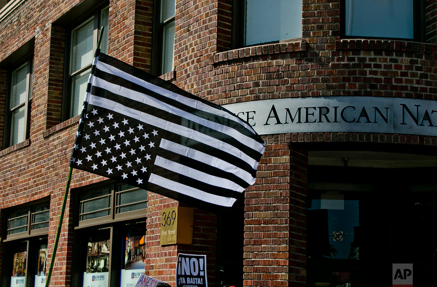  Protesters carry an upside down U.S. flag outside the Japanese American Museum in downtown Los Angeles on Sunday, Aug. 13, 2017 Protesters decrying hatred and racism converged around the country Sunday, the day after a white supremacist rally that s