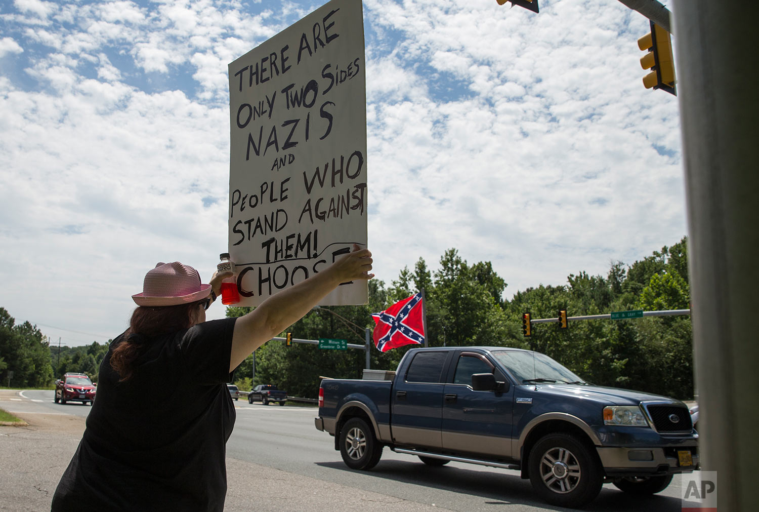  Kim Wyman of Spotsylvania, Va.,  joined more than 60 demonstrators at the intersection of the Blue and Gray Parkway and William Street in Fredericksburg, Va., Sunday, Aug. 13, 2017, to protest against hate and racism in the wake of violence in Charl