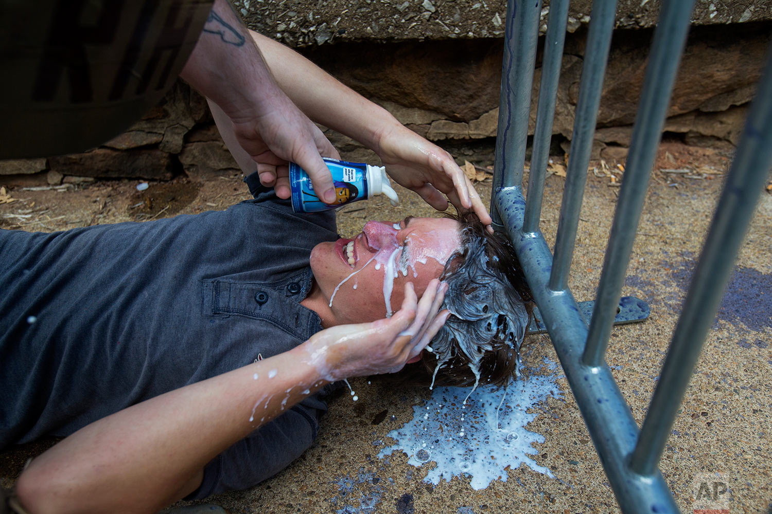  A counter-protester gets milk poured onto his face after getting pepper sprayed during a white nationalist rally on Saturday Aug. 12, 2017, in Charlottesville, Va. (Shaban Athuman /Richmond Times-Dispatch via AP) 