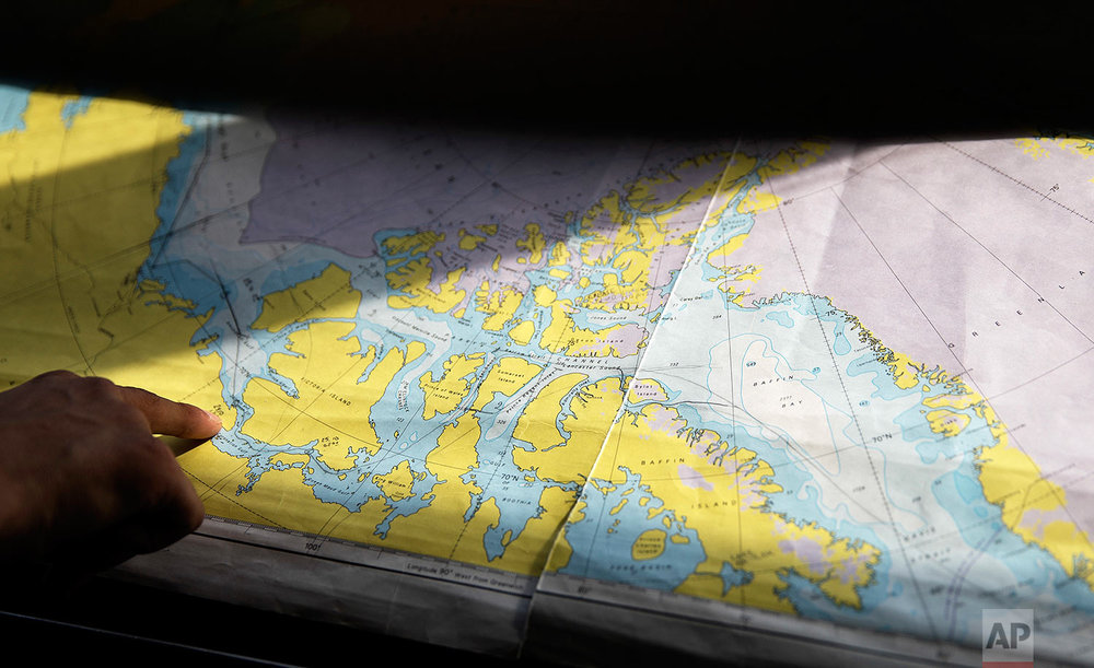  Trainee David Kullualik looks at a map of the Canadian Arctic Archipelago as the Finnish icebreaker MSV Nordica traverses the Northwest Passage, Monday, July 24, 2017. Researchers on the trip sought to observe the changes taking place in the region 
