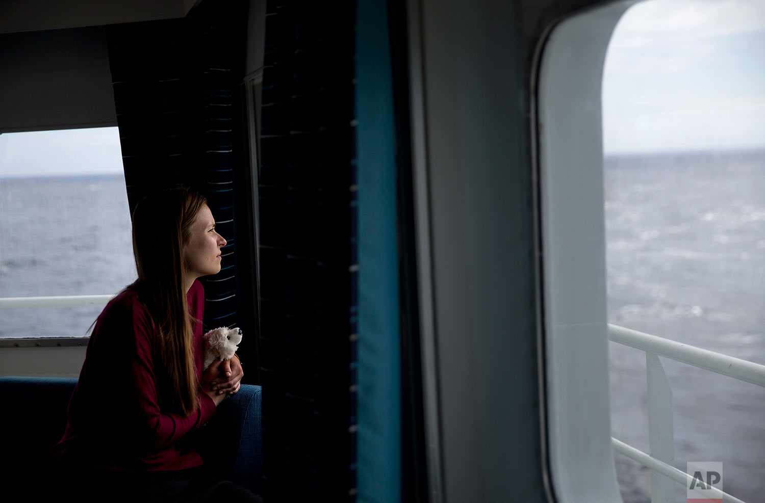  Researcher Daria Gritsenko holds her stuffed polar bear, Umka, while looking out from the Finnish icebreaker MSV Nordica as it sails the North Pacific Ocean to traverse the Northwest Passage through the Canadian Arctic Archipelago Monday, July 10, 2