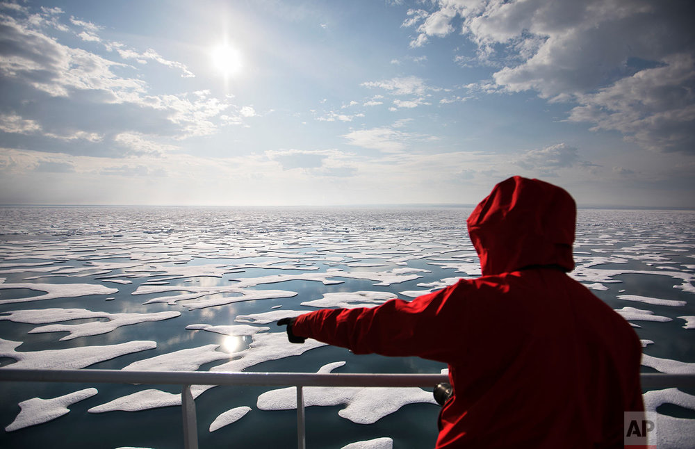  Researcher Tiina Jaaskelainen points out a possible sighting of wildlife aboard the Finnish icebreaker MSV Nordica as it traverses the Northwest Passage through the Canadian Arctic Archipelago, Saturday, July 22, 2017. As the icebreaker entered Vict