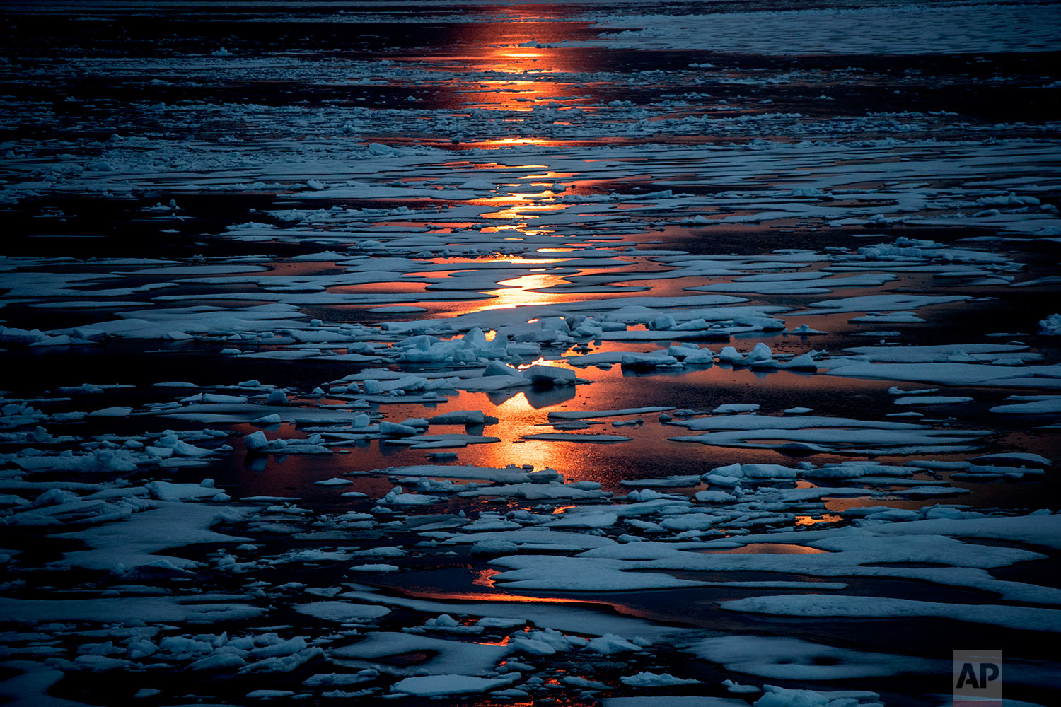  The midnight sun shines across sea ice along the Northwest Passage in the Canadian Arctic Archipelago, Sunday, July 23, 2017. The melting ice is one reason why modern ships have an easier time going through the Northwest Passage, 111 years after Nor