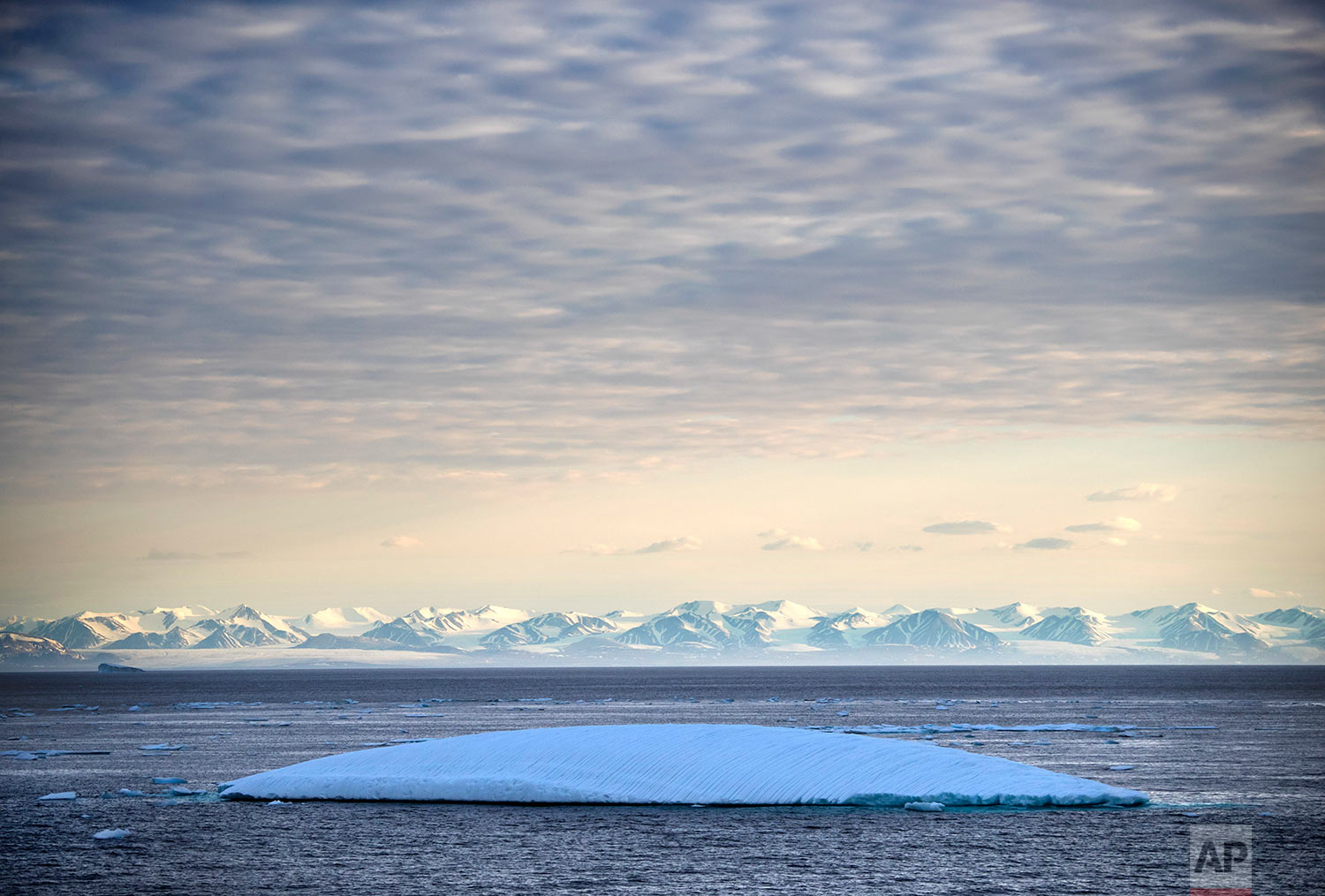  An iceberg floats past Bylot Island in the Canadian Arctic Archipelago, Monday July. 24, 2017. If parts of the planet are becoming like a furnace because of global warming, then the Arctic is best described as the world's air-conditioning unit. The 