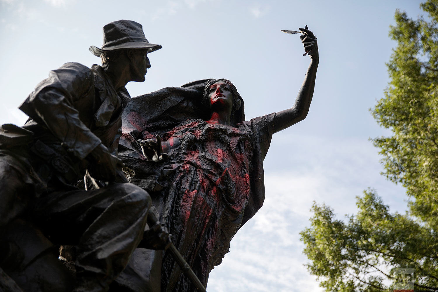  A statue depicting a Confederate soldier in Piedmont Park in Atlanta is vandalized with spray paint Monday, Aug. 14, 2017, from protesters who marched through the city last night to protest the weekend violence in Charlottesville, Virginia. (AP Phot