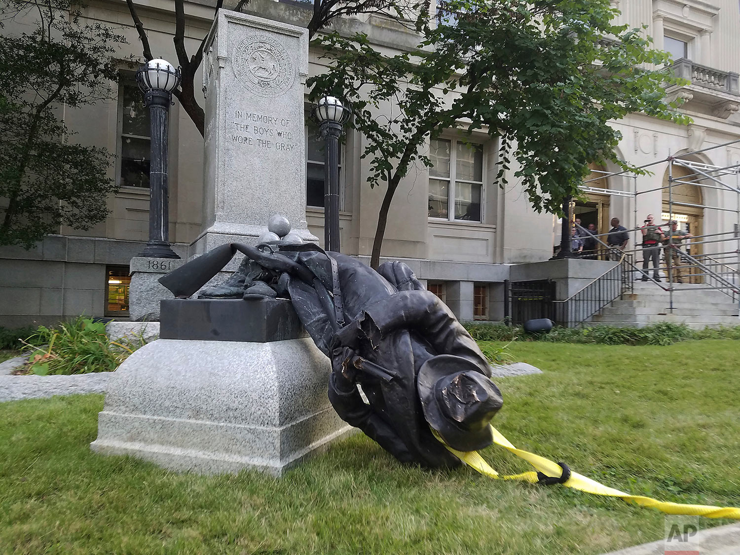  A toppled Confederate statue lies on the ground on Monday, Aug. 14, 2017, in Durham, N.C. Activists on Monday evening used a rope to pull down the monument outside a Durham courthouse. The Durham protest was in response to a white nationalist rally 