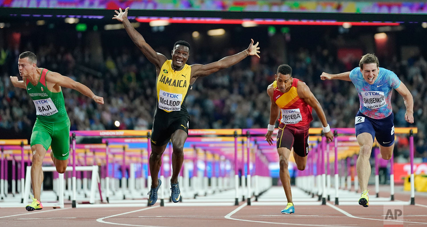  Jamaica's Omar Mcleod, second left, celebrates as he wins the gold medal in the final of the Men's 110m hurdles during the World Athletics Championships in London Monday, Aug. 7, 2017. At right Russia's Sergey Shubenkov, who took silver and at left 