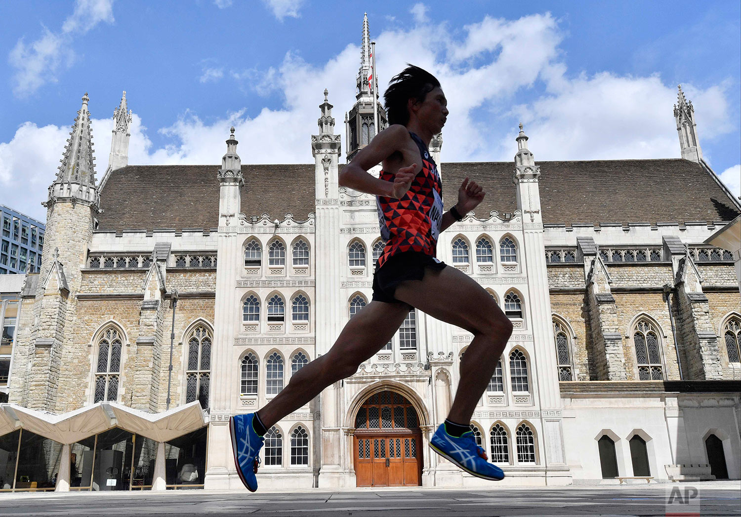  Japan's Kentaro Nakamoto runs past the Guildhall in the Men's Marathon during the World Athletics Championships Sunday, Aug. 6, 2017. (AP Photo/Martin Meissner) 