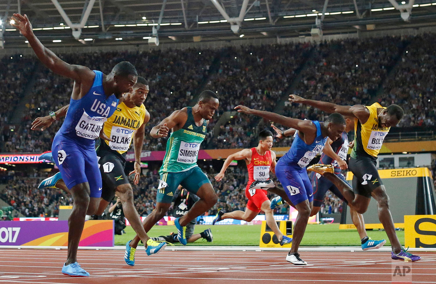  United States' Justin Gatlin, left, crosses the line to win gold ahead of silver medal winner United States' Christian Coleman, second right, and bronze medal winner Jamaica's Usain Bolt, right, in the men's 100m final during the World Athletics Cha