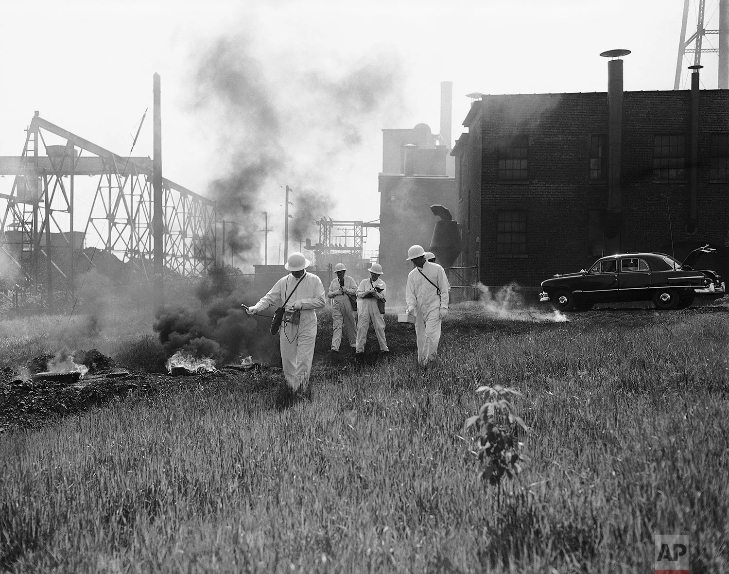 In this May 26, 1951 photo, a radiological team checks a "bombed" area for radiation after a simulated atomic bombing in Utica, N.Y. (AP Photo/Arthur Z. Brooks)