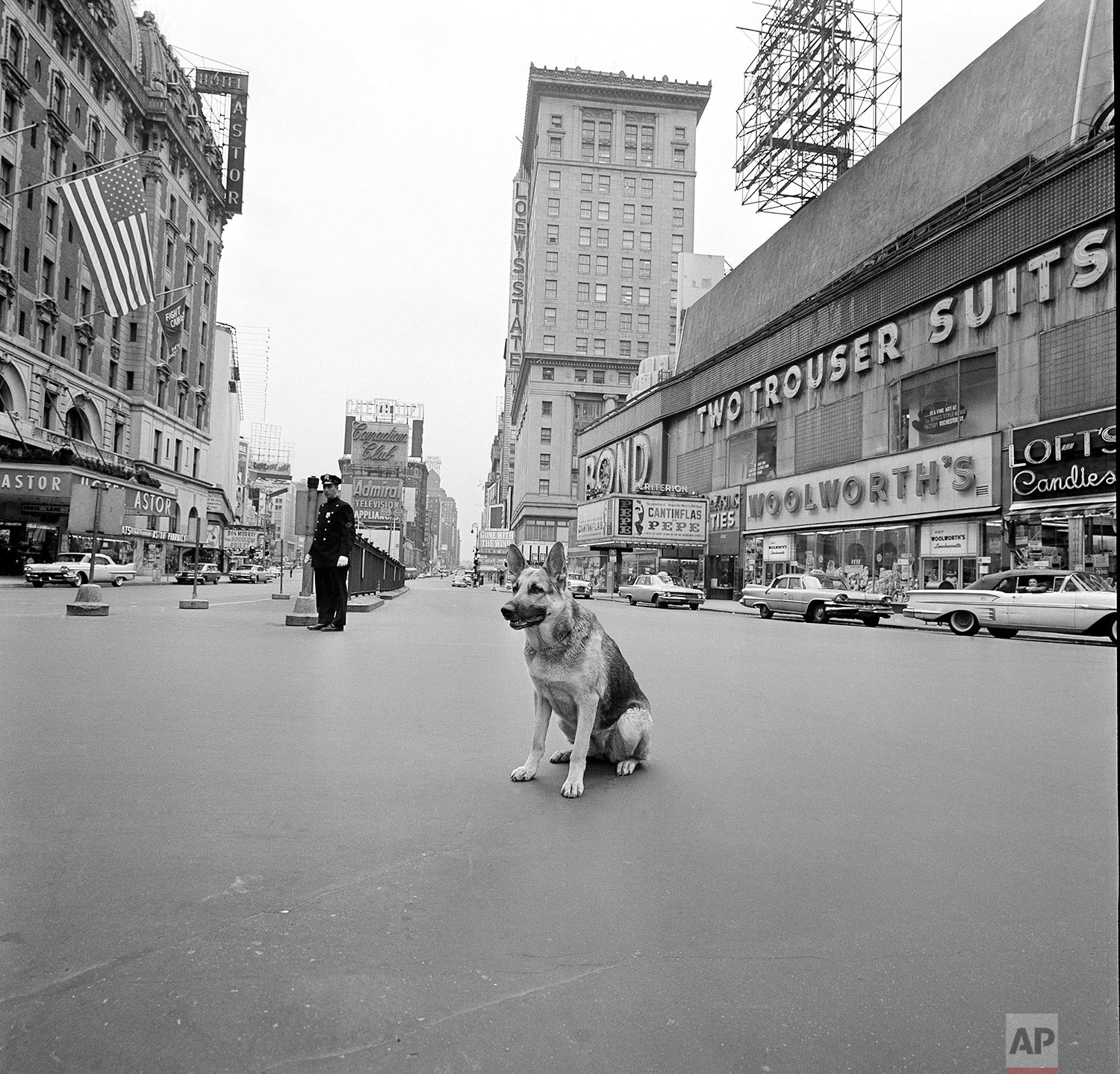 In this April 28, 1961 photo, a dog sits near a police officer in the middle of an empty Times Square during a 10-minute civil defense test air raid alert in New York. For some baby boomers, North Korea's nuclear advances and the Trump administration's bellicose response have prompted flashbacks to a time when they were young, and when they prayed each night that they might awaken the next morning. For their children, the North Korean crisis was a taste of what the Cold War was like. (AP Photo/Bob Goldberg)