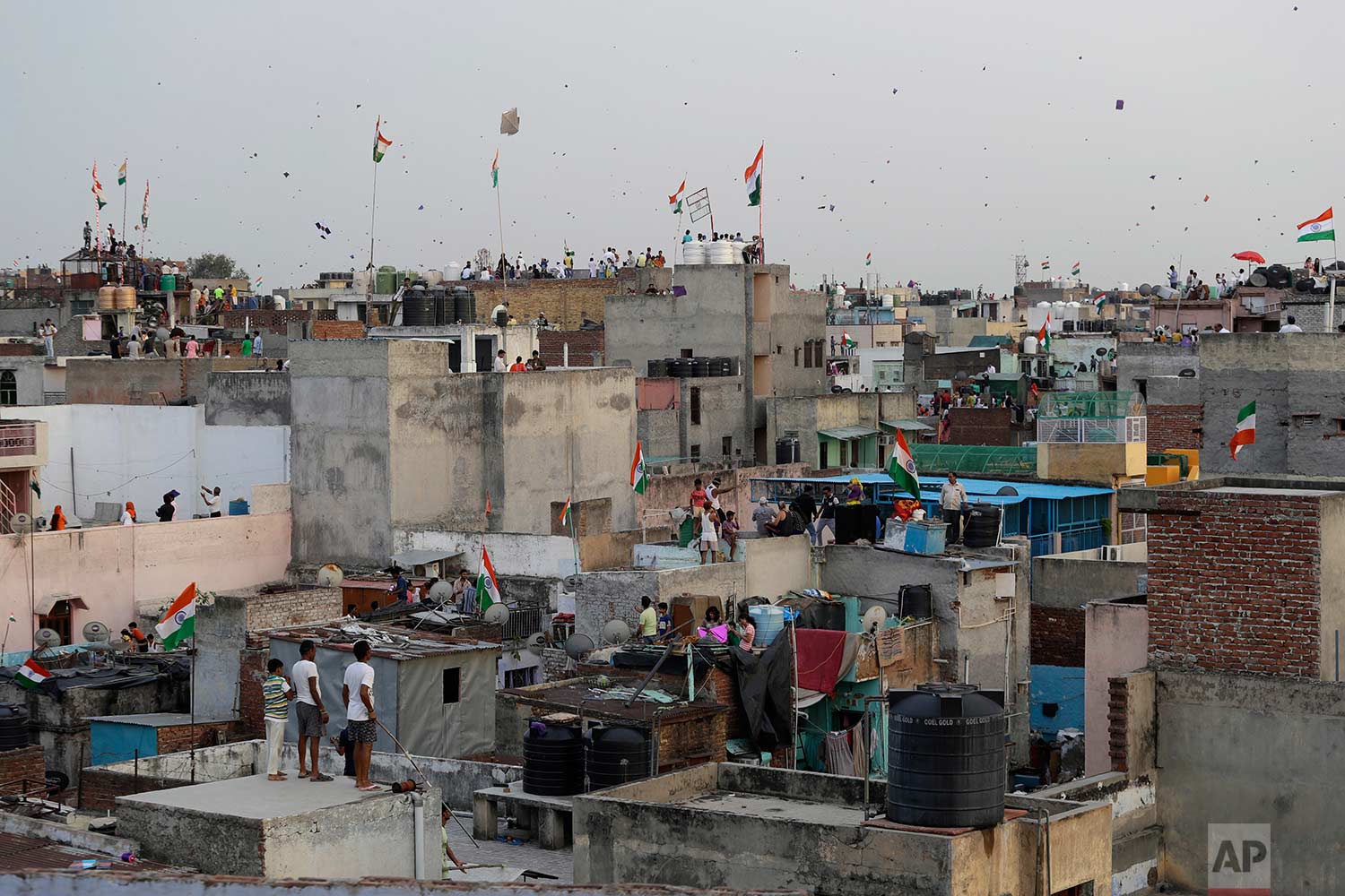  In this Tuesday, Aug. 15, 2017 photo, Indians fly kites on rooftops during Independence Day celebrations in the old quarters of New Delhi, India. (AP Photo/Tsering Topgyal) 