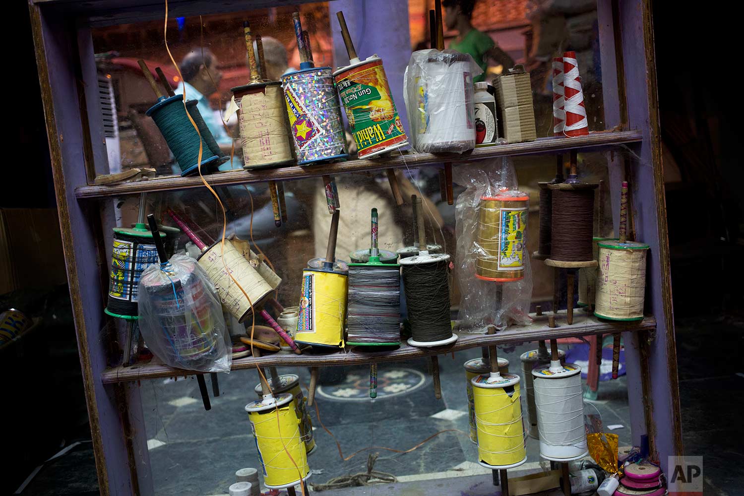  Rolls of kite strings are displayed for sale in the old quarters of New Delhi, India, Thursday, Aug. 17, 2017. (AP Photo/Tsering Topgyal) 