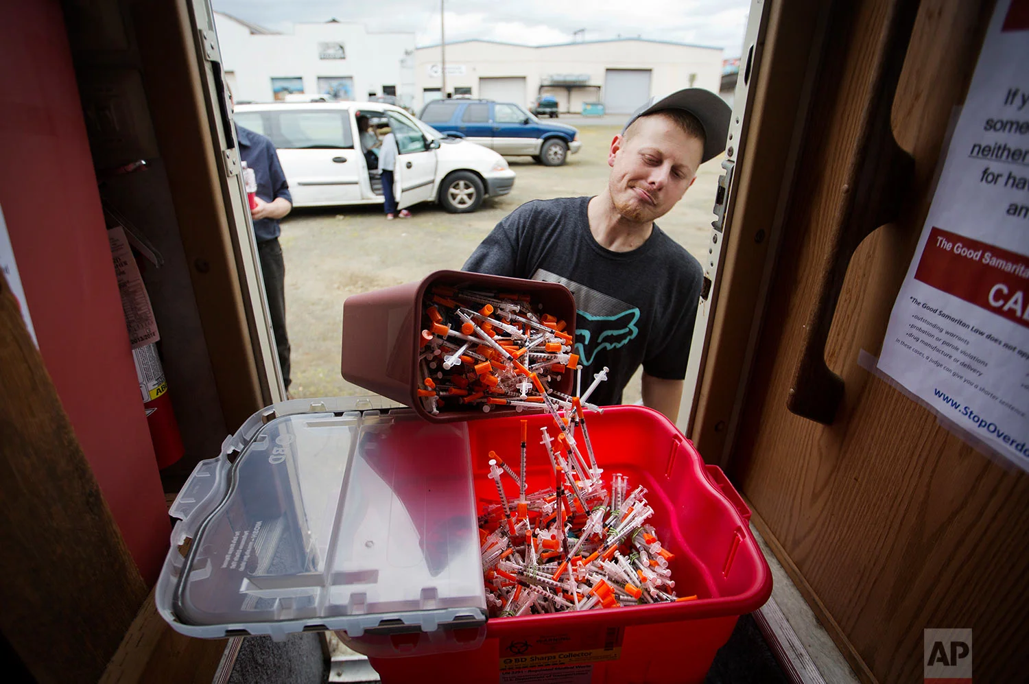 Chris Burkett deposits old needles for new ones at a needle exchange program run by the Grays Harbor County Public Health and Social Services Department in Aberdeen, Wash., Wednesday June 14, 2017. Grays Harbor County public health department last year collected 750,000 needles at its syringe exchange designed to stem the tide of disease, an incredible number for a small town, but still down from more than 900,000 the year before. They attribute that improvement to the methadone clinic that helps nearly 500 people stay off drugs. (AP Photo/David Goldman)