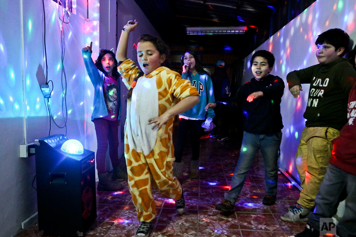  In this July 22, 2017 photo, Selenna, sporting a giraffe costume for the fun of it, dances with other kids at the end of a gender identity workshop at a community center in Santiago, Chile. Selenna said she never liked celebrating her birthday becau