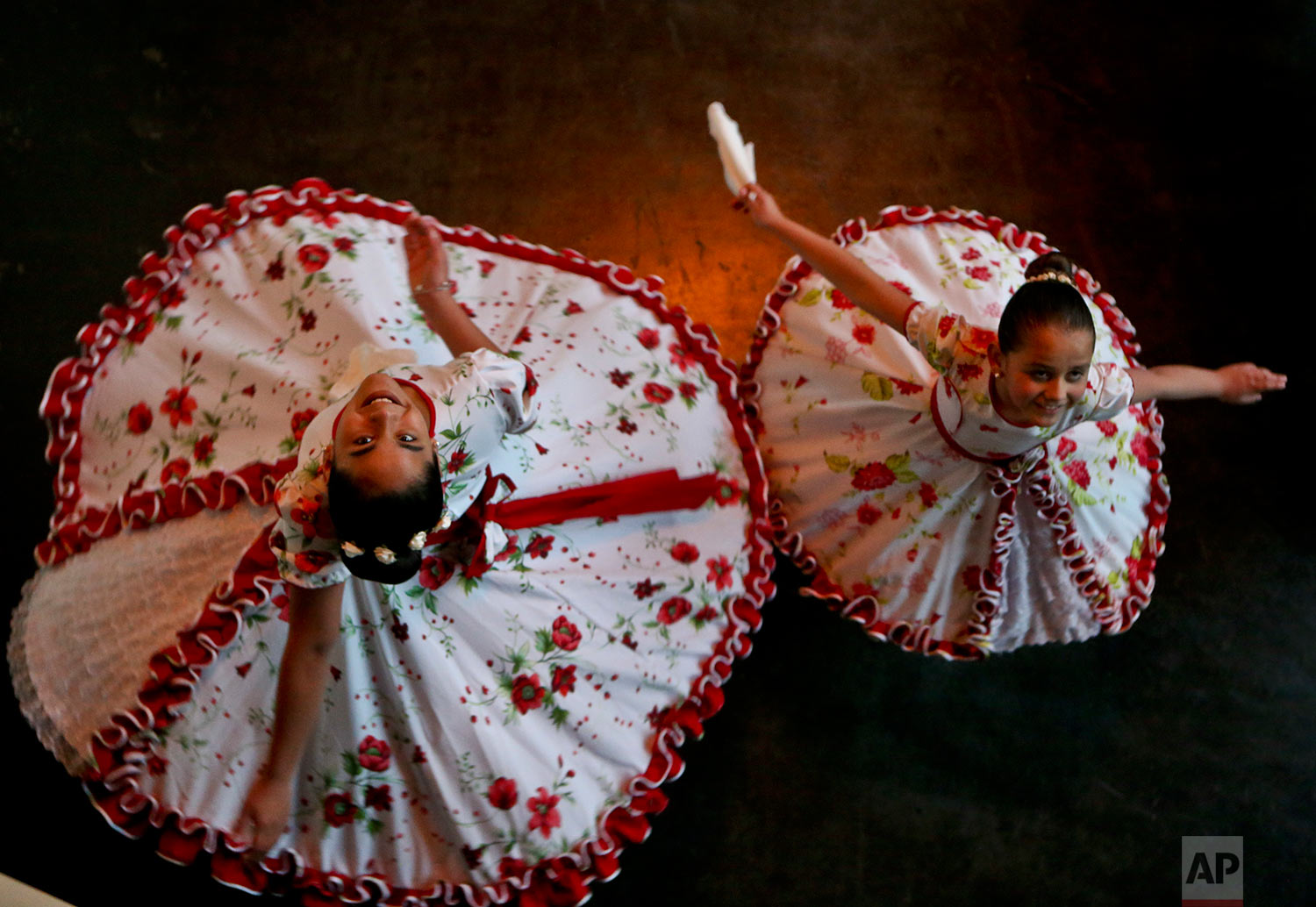  In this Aug. 19, 2017 photo, transgender girls Josefa, 13, left, and Selenna, 8, pose for a picture as they twirl in traditional Chilean dance costumes before an event marking Transgender Children Day in Santiago, Chile. The center-left government h