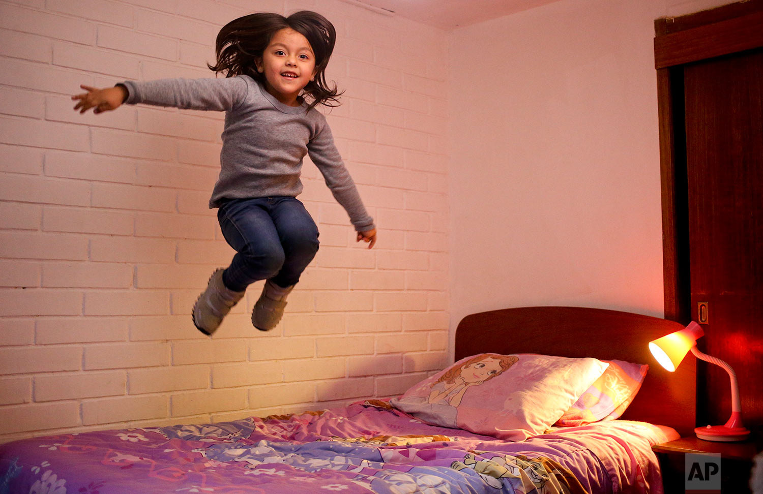  In this July 9, 2017 photo,  Mathilda jumps on her bed as the poses for a picture at her home in Santiago, Chile. Mathilda, 6, was born a boy but began identifying herself as a girl one year ago, and is accepted as a girl by her classmates and teach