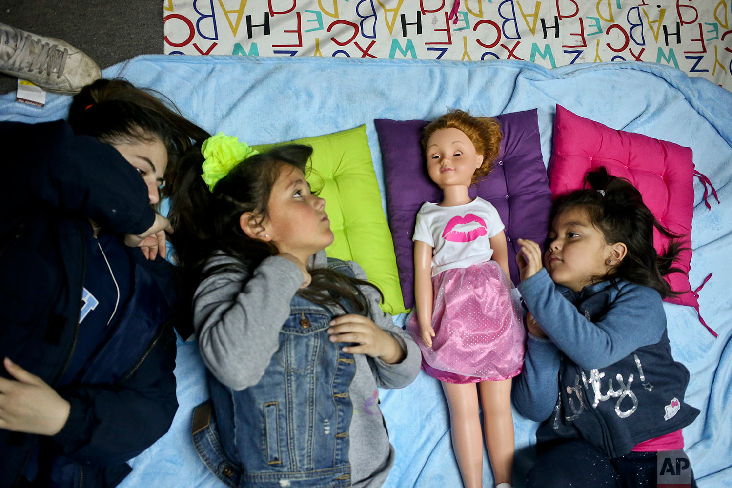  In this July 8, 2017 photo, transgender girls Selenna, second from left, and Mathilda, right, play with a doll as their mothers attend a meeting on gender identity at a bookshop in Santiago, Chile. Selenna said she never liked celebrating her birthd