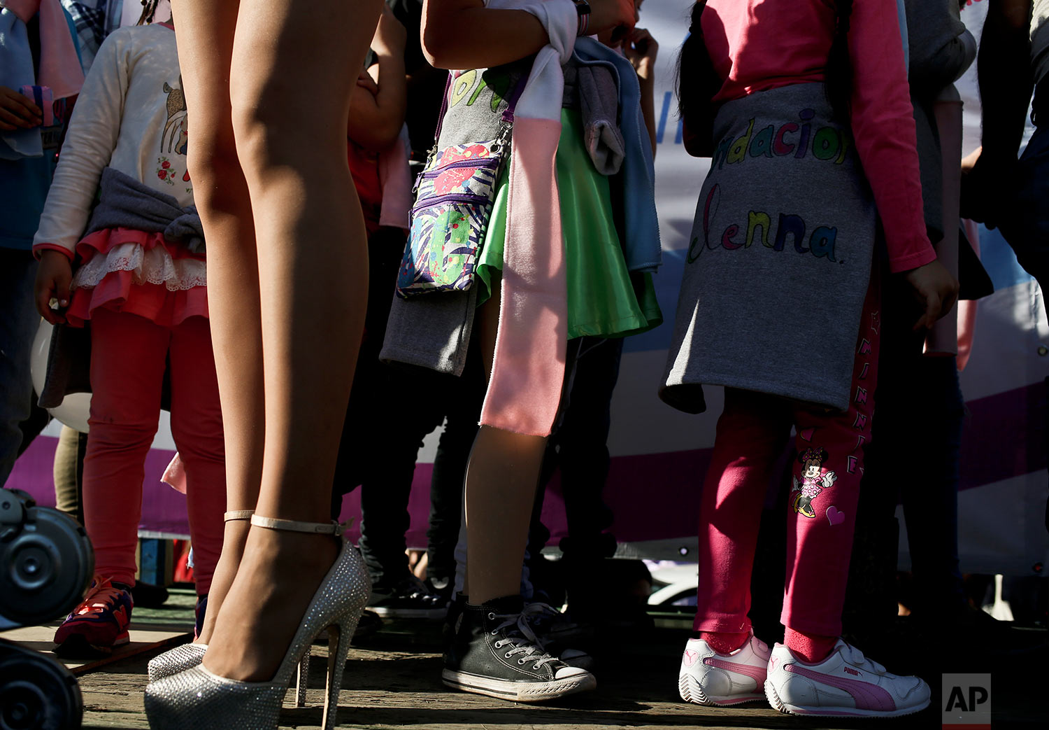  In this July 1, 2017 photo, transgender girls stand by a transvestite during a Gay Pride march in Santiago, Chile. The center-left government has been pushing an array of measures for gender rights, ranging from decriminalizing some abortions to dem