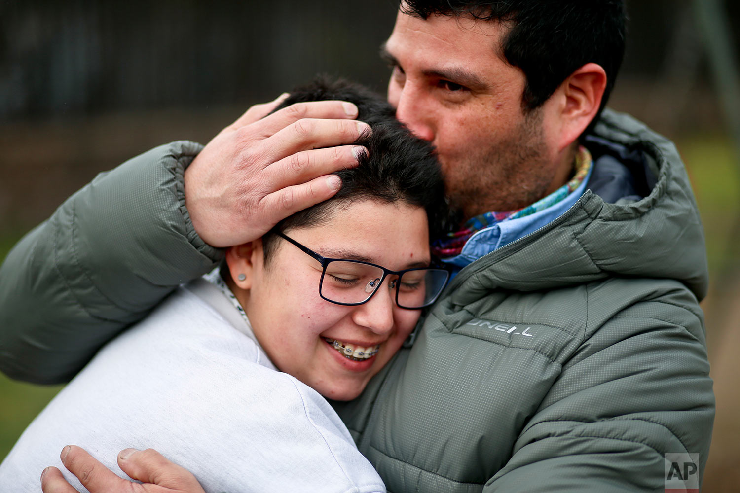  In this Aug. 15, 2017 photo, transgender boy Valentin, 16, is embraced by his father Juan Carlos at a park in Santiago, Chile. Valentin and his father were at the park for a workshop that focused on gender and empowerment. (AP Photo/Esteban Felix) 