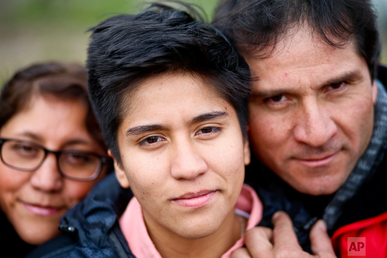  In this Aug. 15, 2017 photo, transgender boy Tobias, 16, poses for a portrait with his parents Paulina and Carlos at a park in Santiago, Chile. The family was at the park for a workshop that focused on gender and empowerment. (AP Photo/Esteban Felix