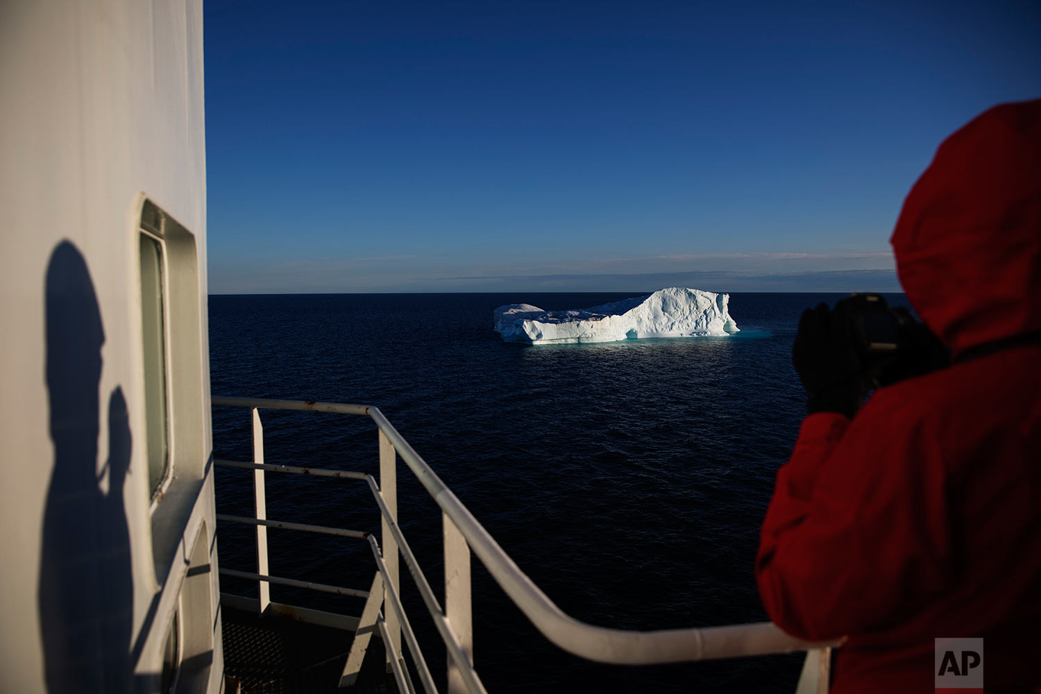  Researcher Tiina Jaaskelainen takes a picture of an iceberg floating in Baffin Bay in the Canadian Arctic Archipelago while aboard the Finnish icebreaker MSV Nordica, Tuesday, July 25, 2017. &nbsp;(AP Photo/David Goldman) 