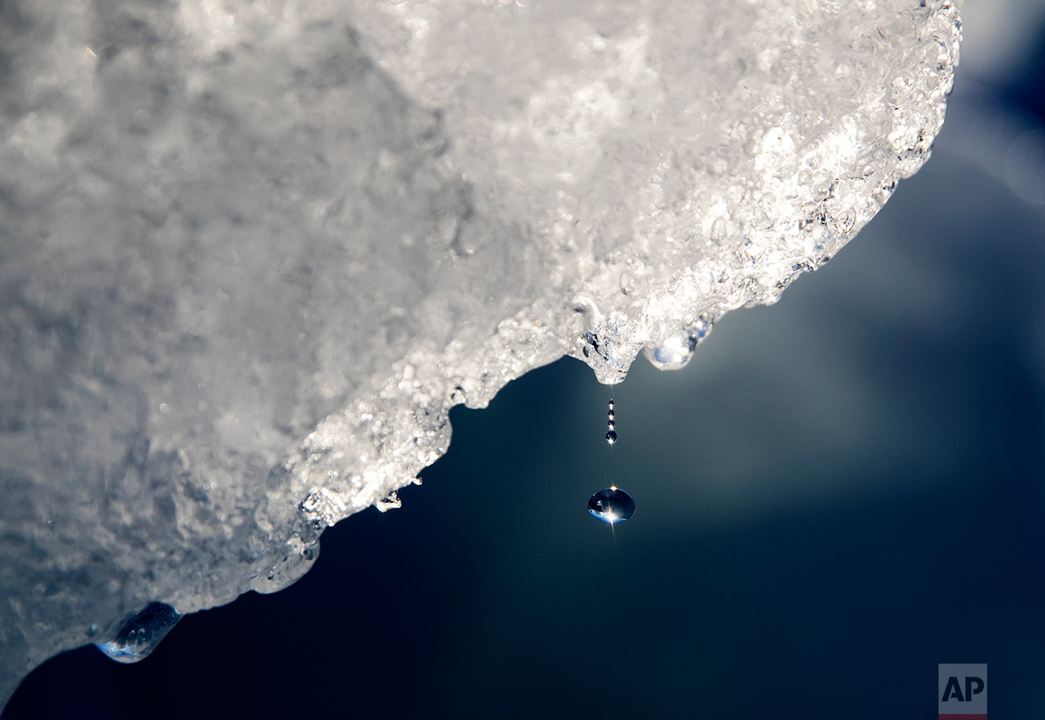  A drop of water falls off an iceberg melting in the Nuup Kangerlua Fjord near Nuuk in southwestern Greenland, Tuesday, Aug. 1, 2017. (AP Photo/David Goldman) 