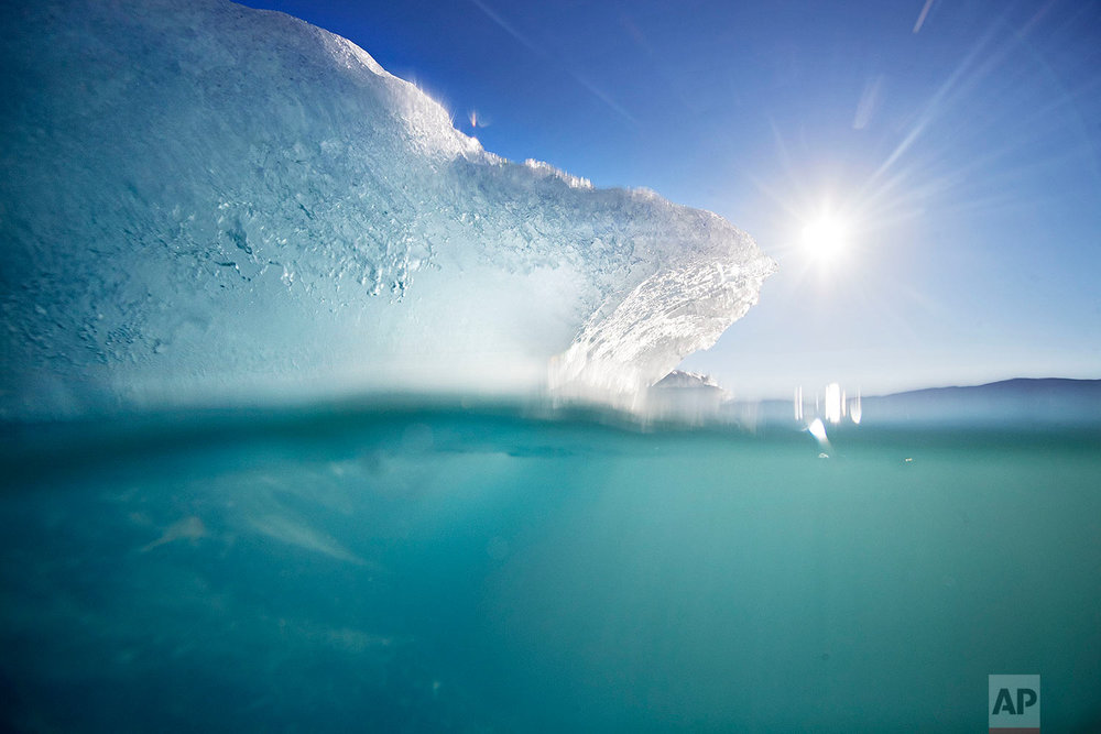  An icebergs floats in the Nuup Kangerlua Fjord near Nuuk in southwestern Greenland, Tuesday, Aug. 1, 2017. (AP Photo/David Goldman) 