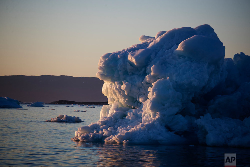  The suns sets against an iceberg floating in the Nuup Kangerlua Fjord near Nuuk in southwestern Greenland, Tuesday, Aug. 1, 2017. (AP Photo/David Goldman) 