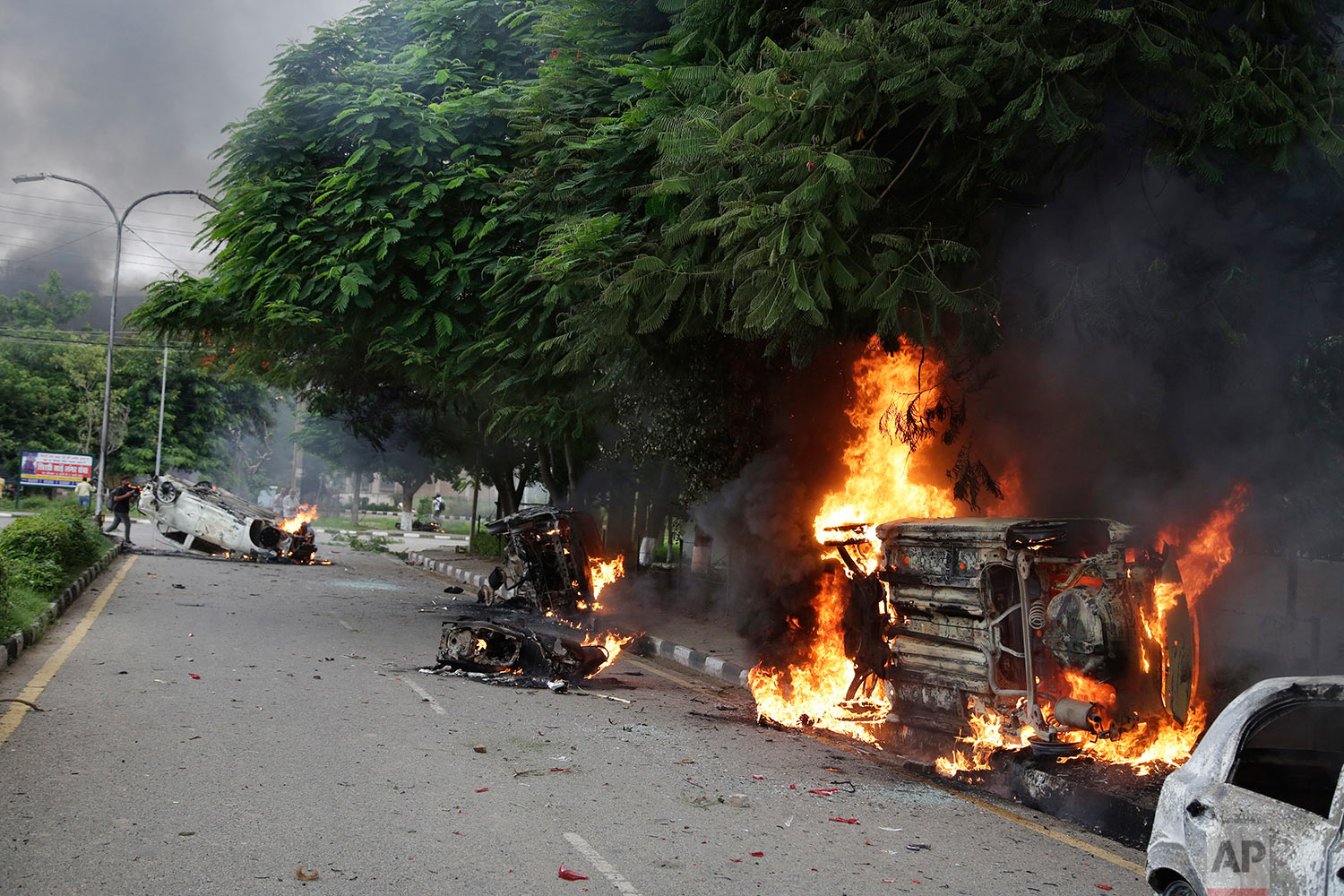  Vehicles set alight by Dera Sacha Sauda sect members burn in the streets of Panchkula, India, Friday, Aug. 25, 2017. (AP Photo/Altaf Qadri) 