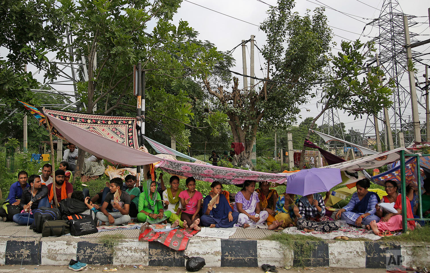  Supporters of the Dera Sacha Sauda sect squat on the roadside leading to an Indian court in Panchkula, India, Thursday, Aug. 24, 2017. (AP Photo/Altaf Qadri) 