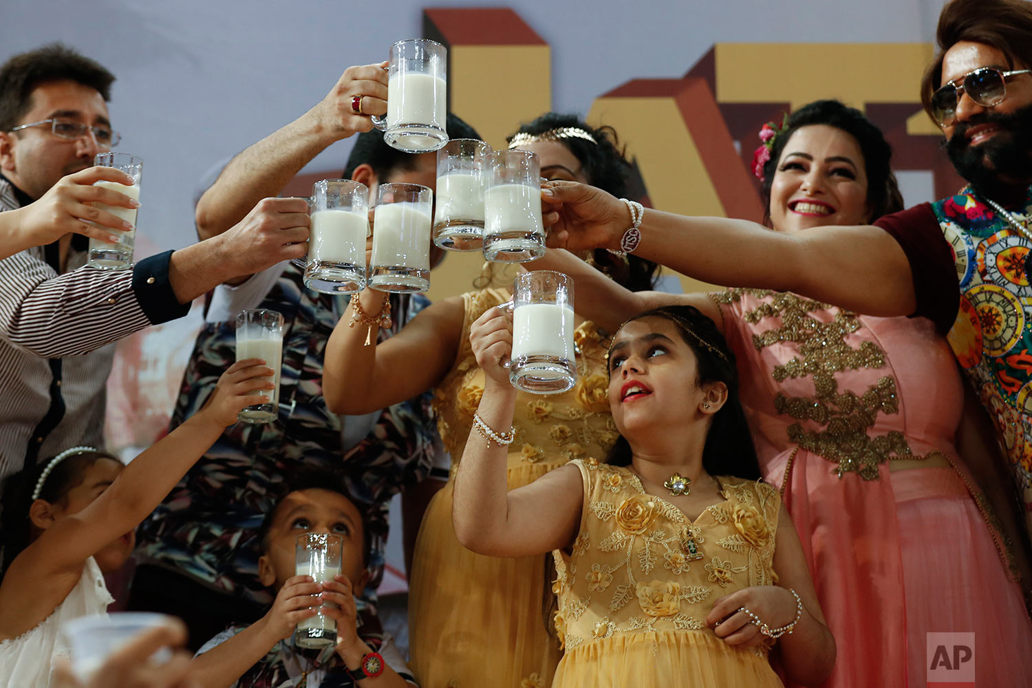  In this May 17, 2017 photo, Indian spiritual leader who calls himself Dr. Saint Gurmeet Singh Ram Rahim Insan, right, and others raise a toast with glasses of milk as they hold a 'Cow Milk Party' during the premiere of the movie "Jattu Engineer" in 