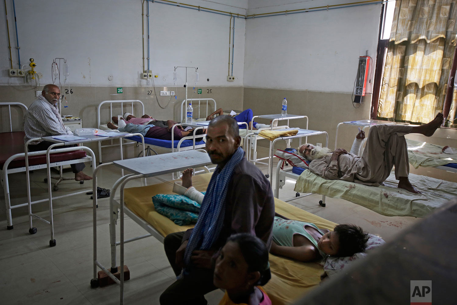  Injured members of Dera Sacha Sauda sect are seen through a glass window as they are treated at a local hospital in Panchkula, India, Saturday, Aug. 26, 2017. (AP Photo/Altaf Qadri) 