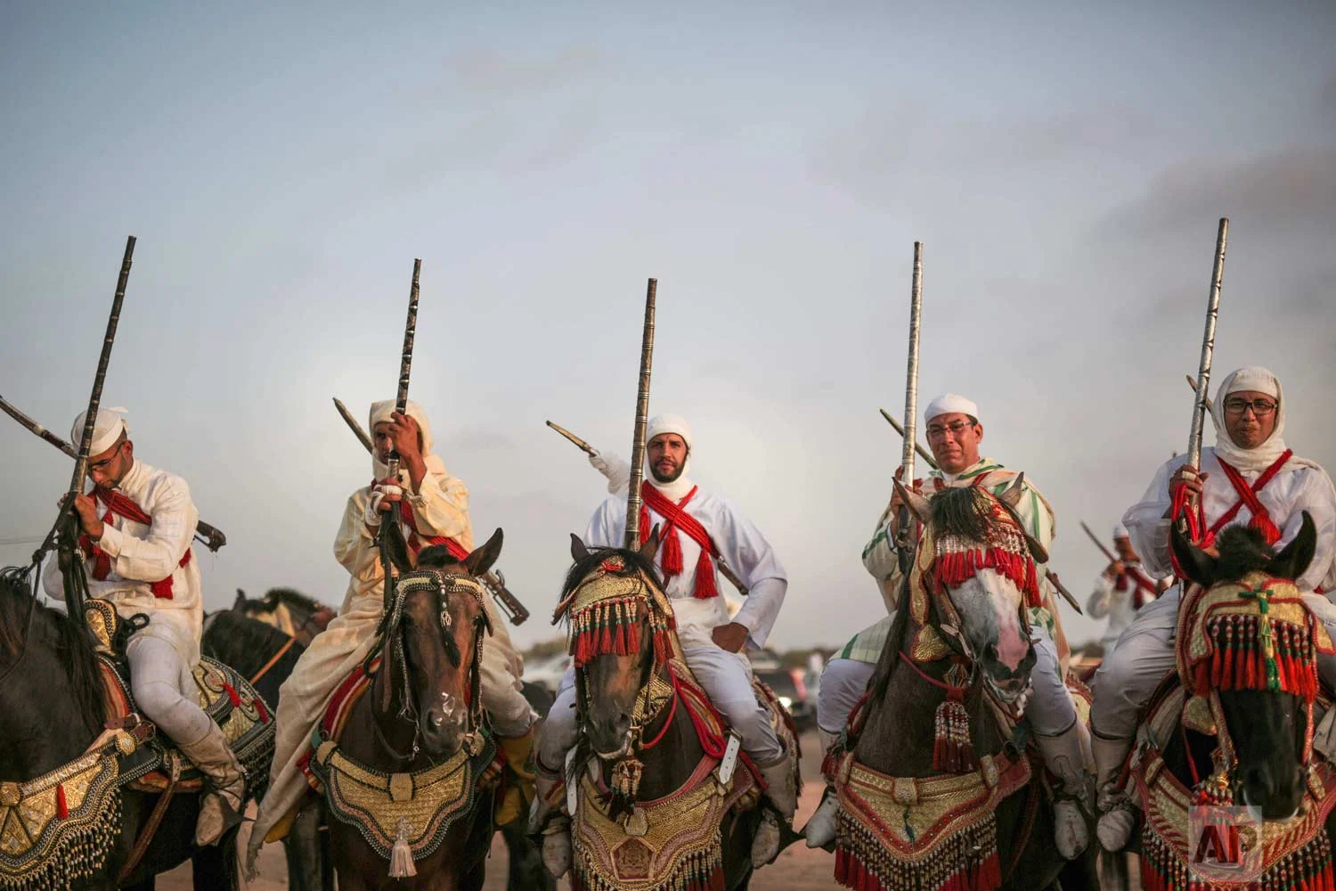 In this Thursday, Aug. 17, 2017 photo, horsemen prepare to take part in Tabourida, a traditional horse riding show also known as Fantasia, in Mansouria, near Casablanca, Morocco. (AP Photo/Mosa'ab Elshamy)