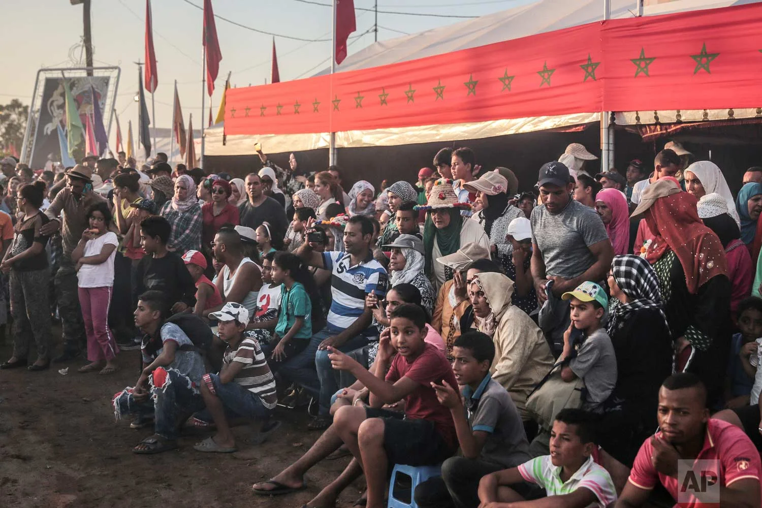 In this Thursday, Aug. 17, 2017 photo, crowds gather to attend and judge the Tabourida, a traditional horse riding show also known as Fantasia, in Mansouria, near Casablanca, Morocco. (AP Photo/Mosa'ab Elshamy)