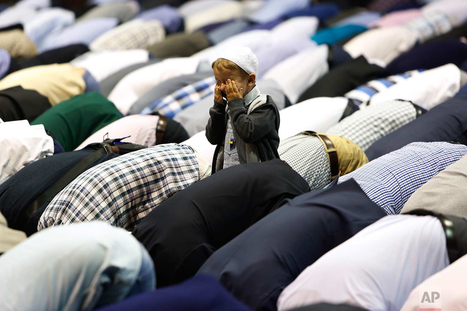  A boy offers Eid al-Adha prayers at the sport center in Sarajevo, Bosnia, Friday, Sept. 1, 2017. (AP Photo/Amel Emric) 