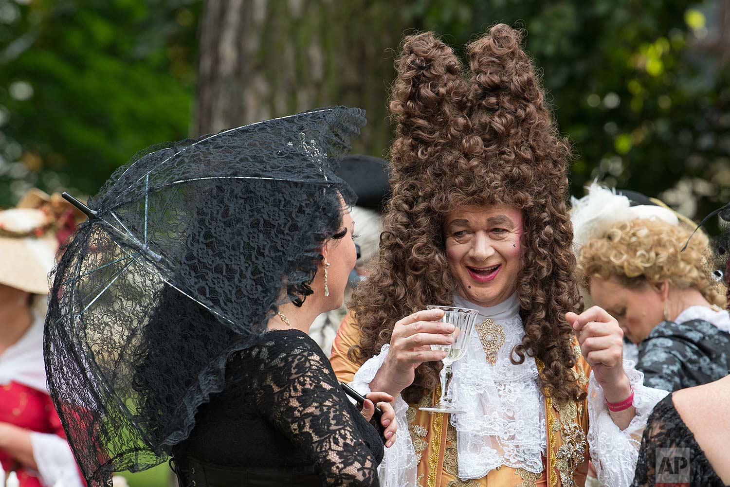 People in period costumes talk outside the Friedenstein Castle at the Baroque Festival in Gotha, Germany, Saturday, Aug. 26, 2017. (AP Photo/Jens Meyer)