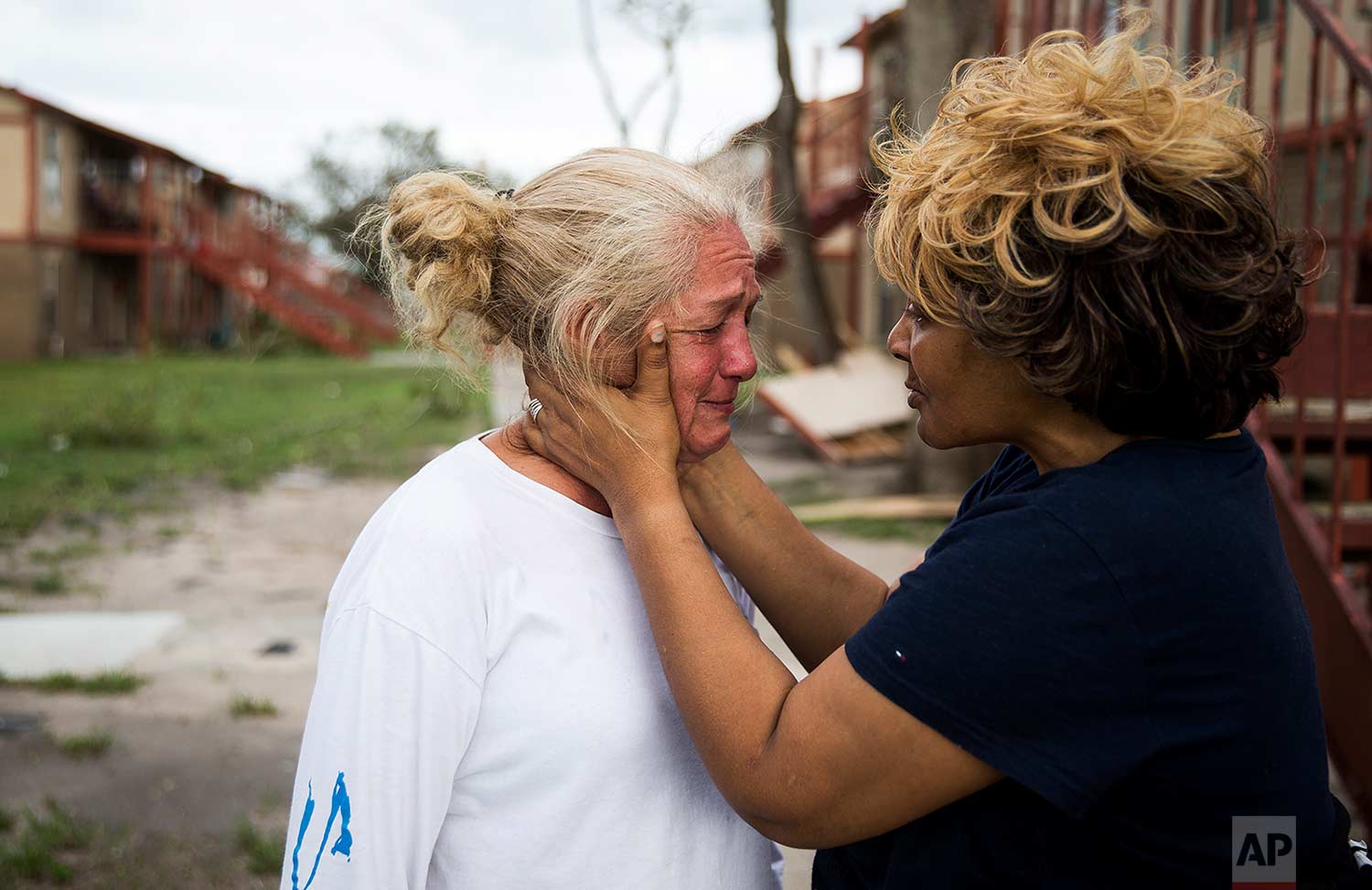  Genice Gipson comforts her lifelong friend, Loretta Capistran, outside of Capistran's apartment complex in Refugio, Texas, on Monday, Aug. 28, 2017. (Nick Wagner/Austin American-Statesman via AP) 