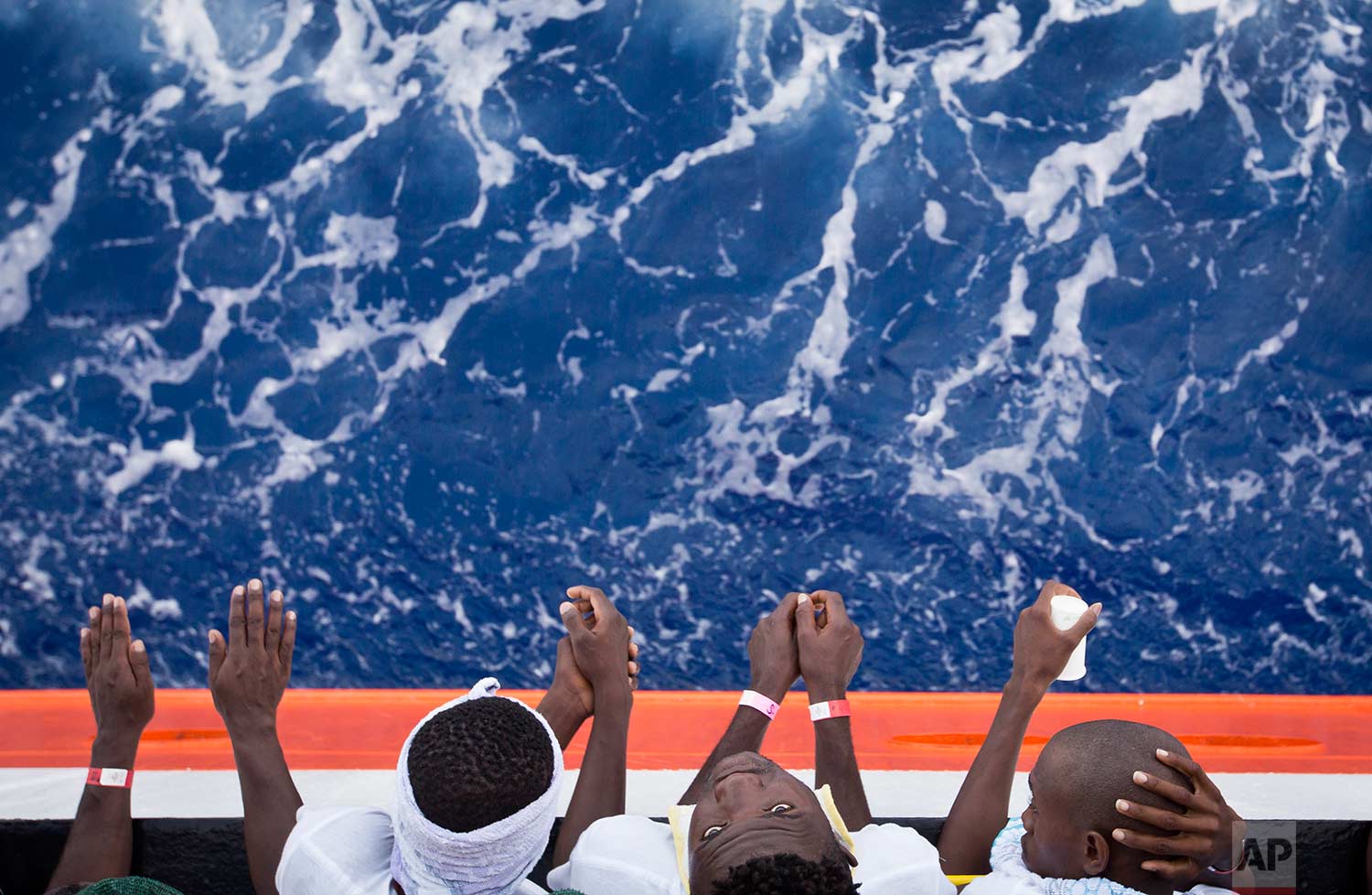  African migrants stand on the deck of the Aquarius vessel of the "SOS Mediterranee" and MSF (Doctors Without Borders) NGOs, in the Mediterranean Sea, southwest of Malta, Thursday, Aug. 31, 2017. (AP Photo/Darko Bandic) 