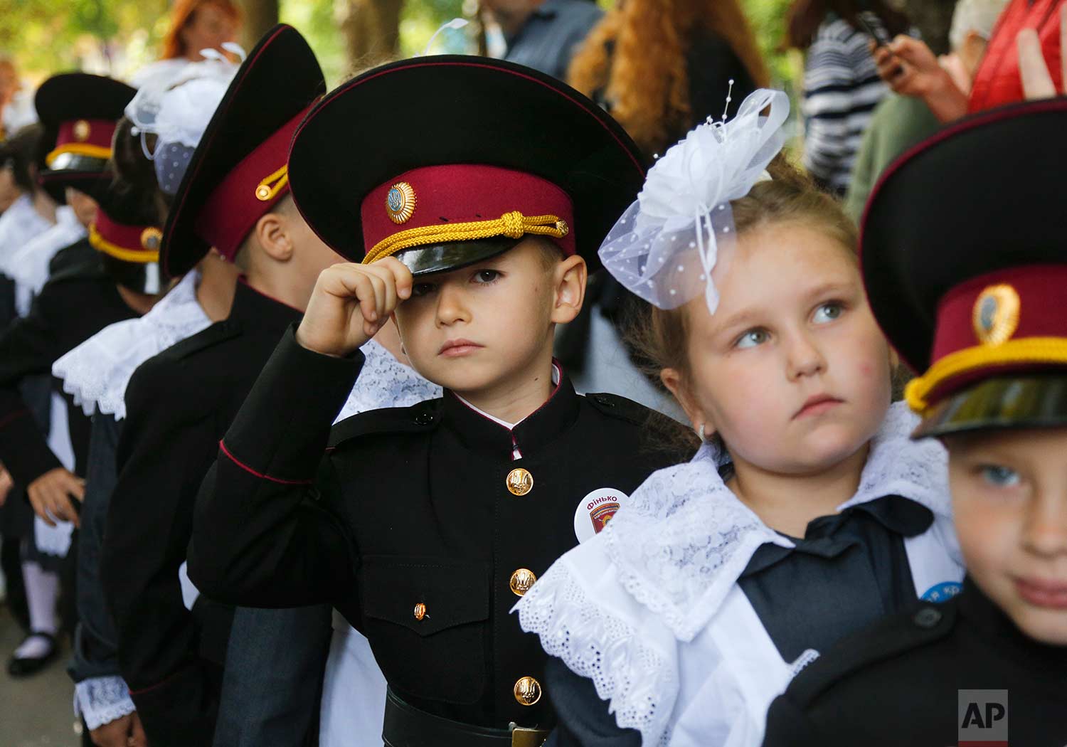  Young cadets and schoolgirls attend a ceremony on the occasion of the first day of school at a cadet lyceum in Kiev, Ukraine, Friday, Sept. 1, 2017. Ukraine marks Sept. 1 as Knowledge Day, as a traditional launch of the academic year. (AP Photo/Efre