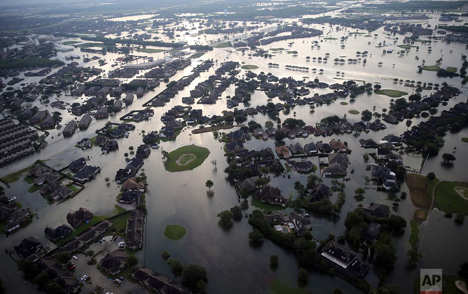 Floodwaters from Tropical Storm Harvey surround homes in Port Arthur, Texas, Thursday, Aug. 31, 2017. (AP Photo/Gerald Herbert)
