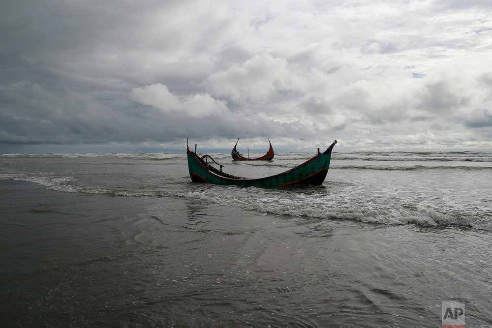  Two among three boats that capsized while being used by fleeing Rohingya is seen on the Bay of Bengal coast, after being recovered by Bangladeshi villagers at Shah Porir Deep, in Teknak, Bangladesh, Thursday, Aug.31, 2017. Three boats carrying ethni