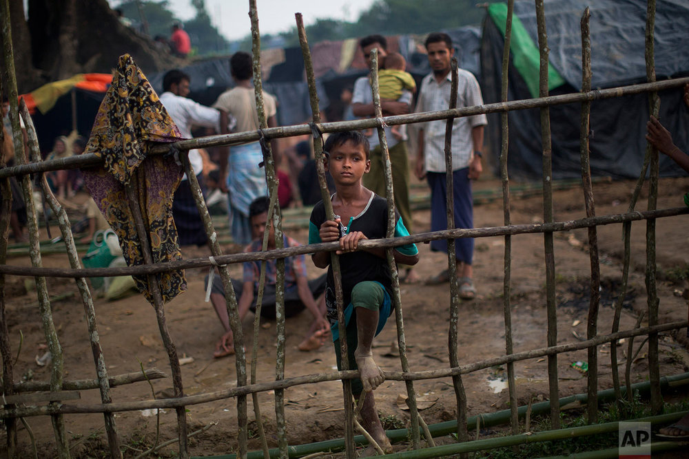  A Rohingya child, newly arrived from Myanmmar to the Bangladesh side of the border, stands by a wooden fence at Kutupalong refugee camp in Ukhia, Tuesday, Sept. 5, 2017. Bangladesh, one of the world's poorest countries, was already sheltering some 1