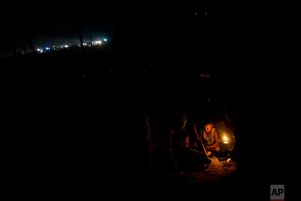  Rohingya Muslims rest inside a new tent next to Kutupalong refugee camp in Ukhia, Bangladesh, Tuesday, Sept. 5, 2017. Bangladesh, one of the world's poorest countries, was already sheltering some 100,000 Rohingya refugees before another 123,000 floo