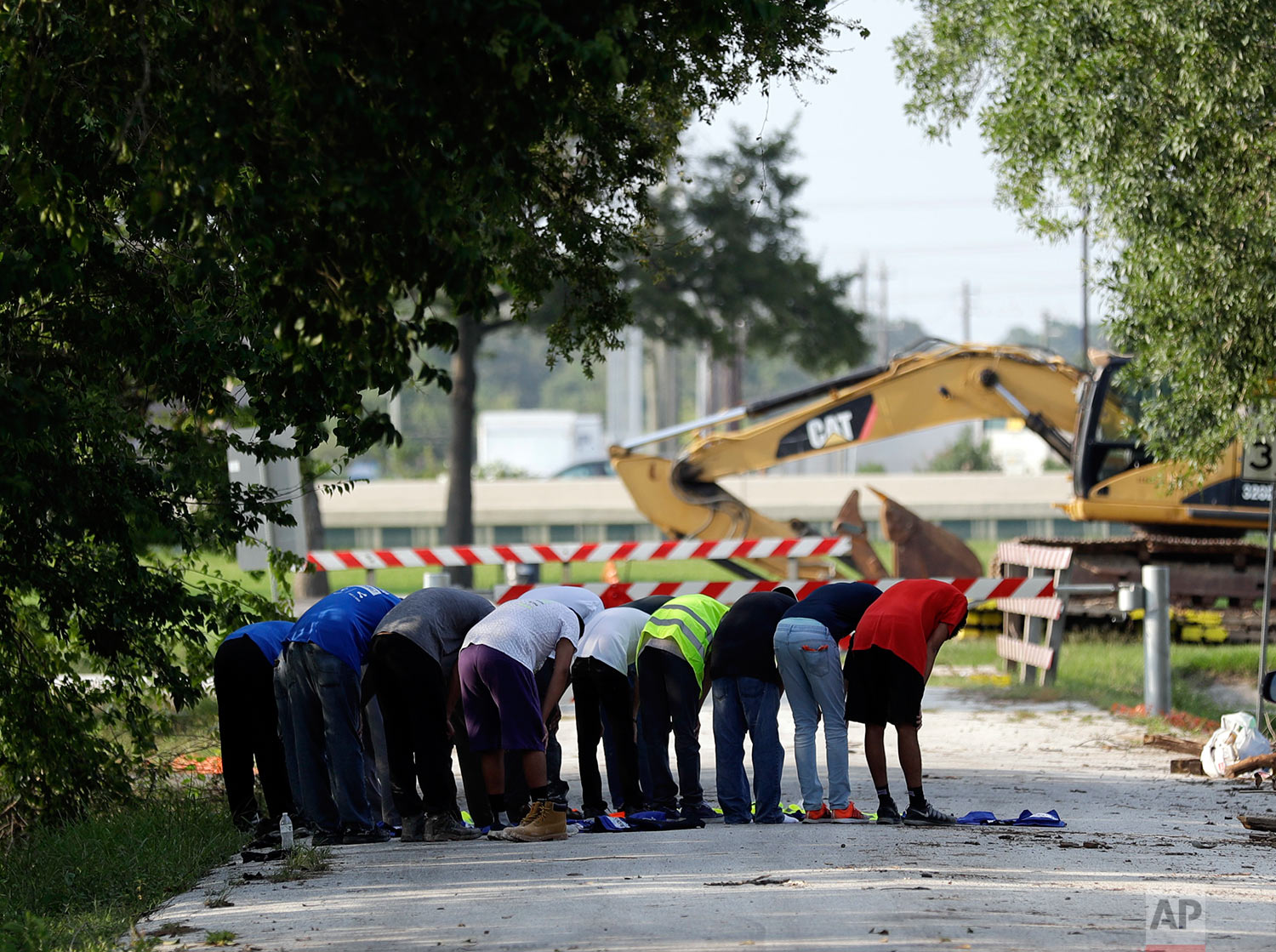  In this Sunday, Sept. 3, 2017, photo, volunteers from the Ahmadiyya Muslim Youth Association take a moment to pray as they help families clean out their flood-damaged homes in Houston. (AP Photo/Gregory Bull) 