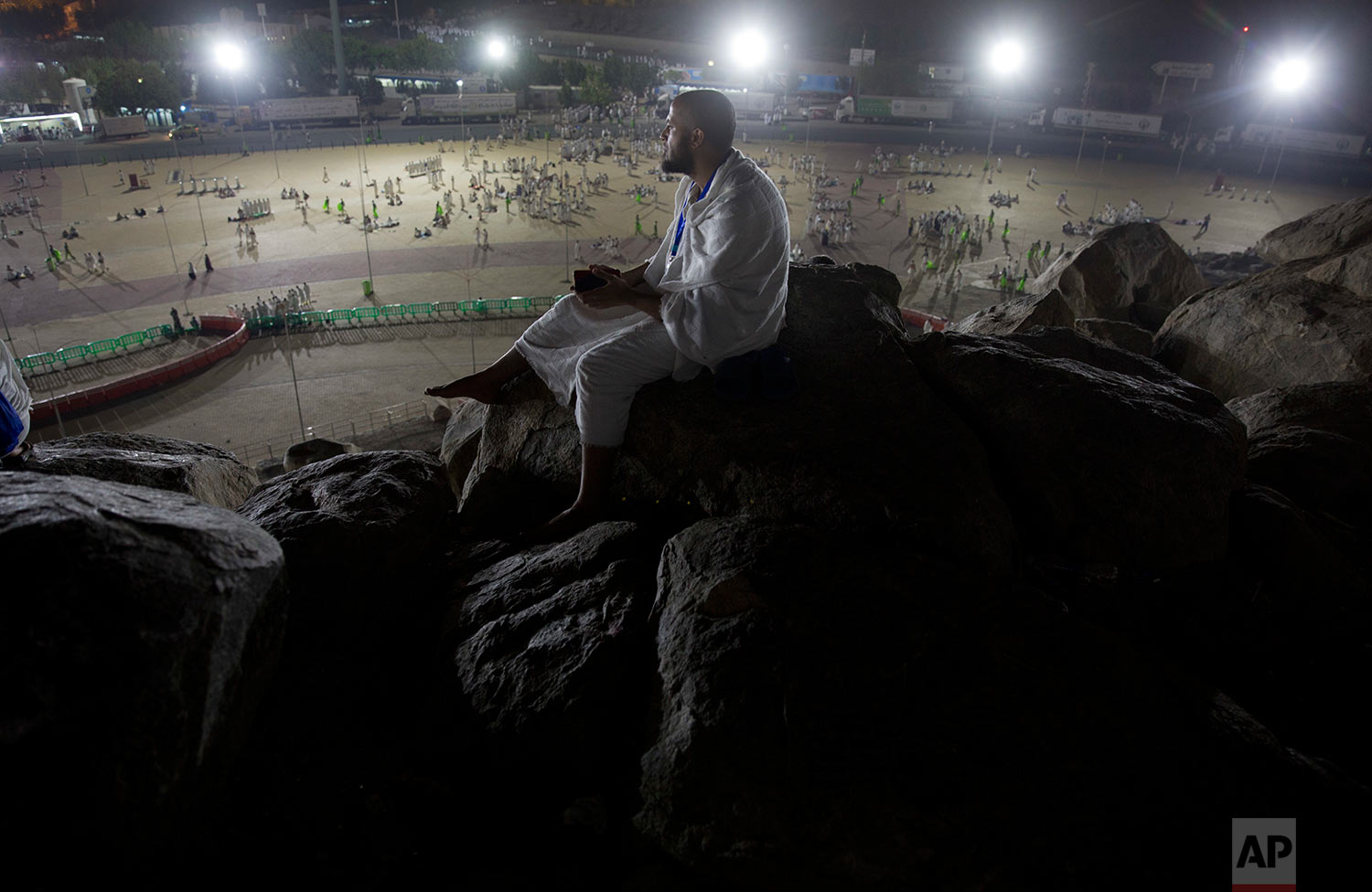  A Muslim pilgrim prays on top of the Jabal Al Rahma holy mountain, or the mountain of forgiveness, upon their arrival to Arafat for the annual hajj pilgrimage, outside the holy city of Mecca, Saudi Arabia, Wednesday, Aug. 30, 2017. (AP Photo/Khalil 