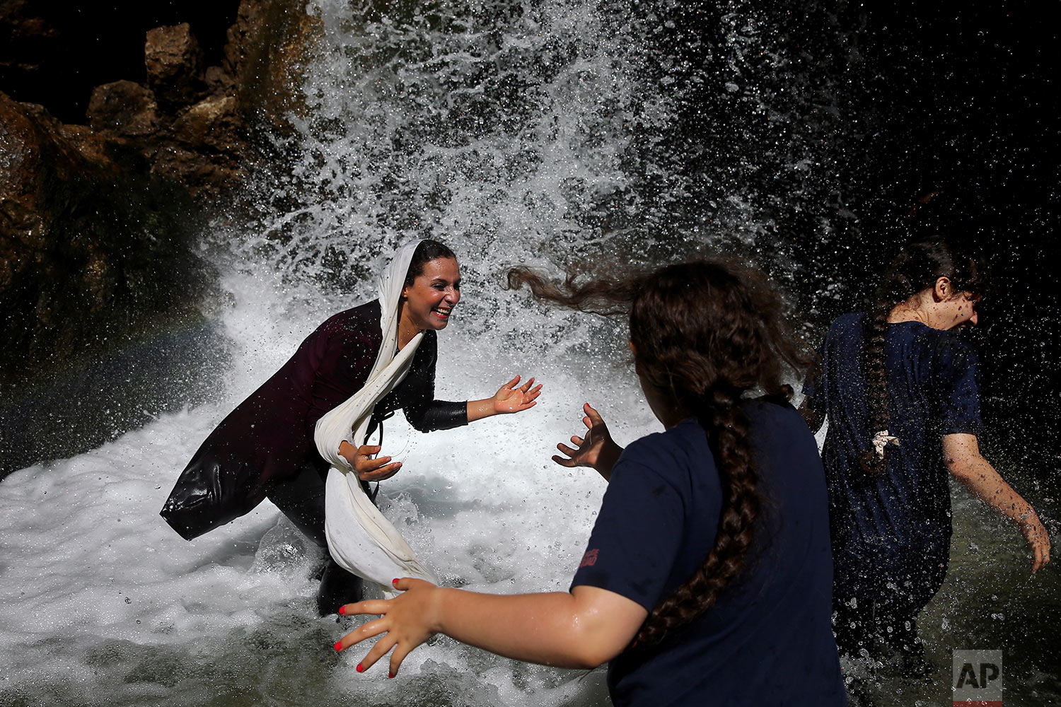  Iranian girls play in a waterfall in the river streaming between two cliffs at Tangeh Vashi canyon, just 99 miles (160 kilometer) north of Tehran, Iran on Aug. 7, 2017. (AP Photo/Ebrahim Noroozi) 